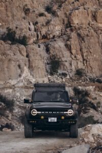 Explore the rugged terrains of Oman with a Ford Bronco, perfect for adventure travel.
